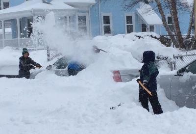 THE BLIZZARD OF 2015—:  A trio of kids worked to dig out a neighor’s car in Lower Mills on Tuesday as a historic blizzard dumped more than 30 inches on the city in places, prompting a snow emergency that ended Wednesday at 5 p.m. Mayor Walsh gave the city’s Public Works department an “A” for its response to the storm. Photo by Bill Forry